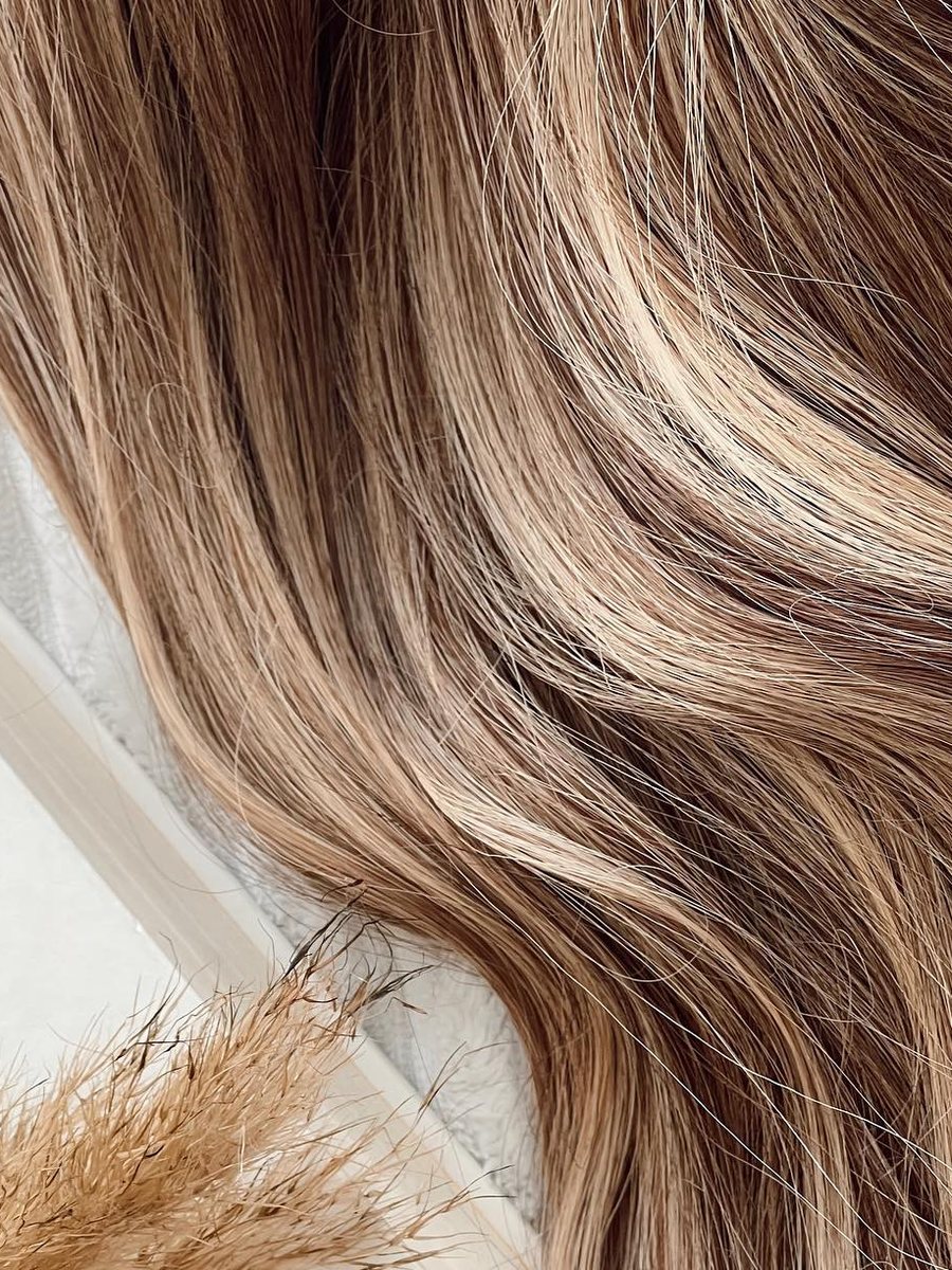 Close-up of blonde highlighted waves, showing soft texture and dimension in the hair.
