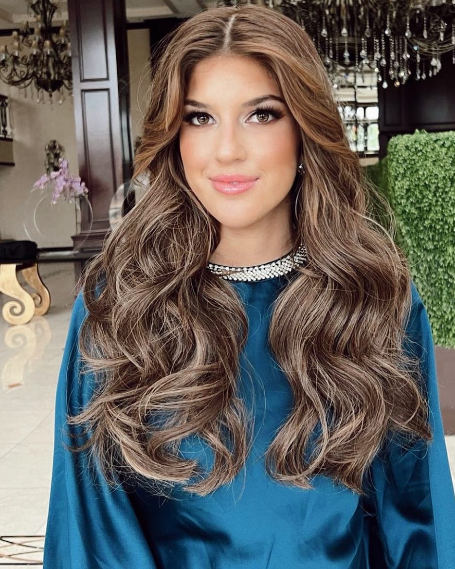 Long, full brunette waves with a teal top.